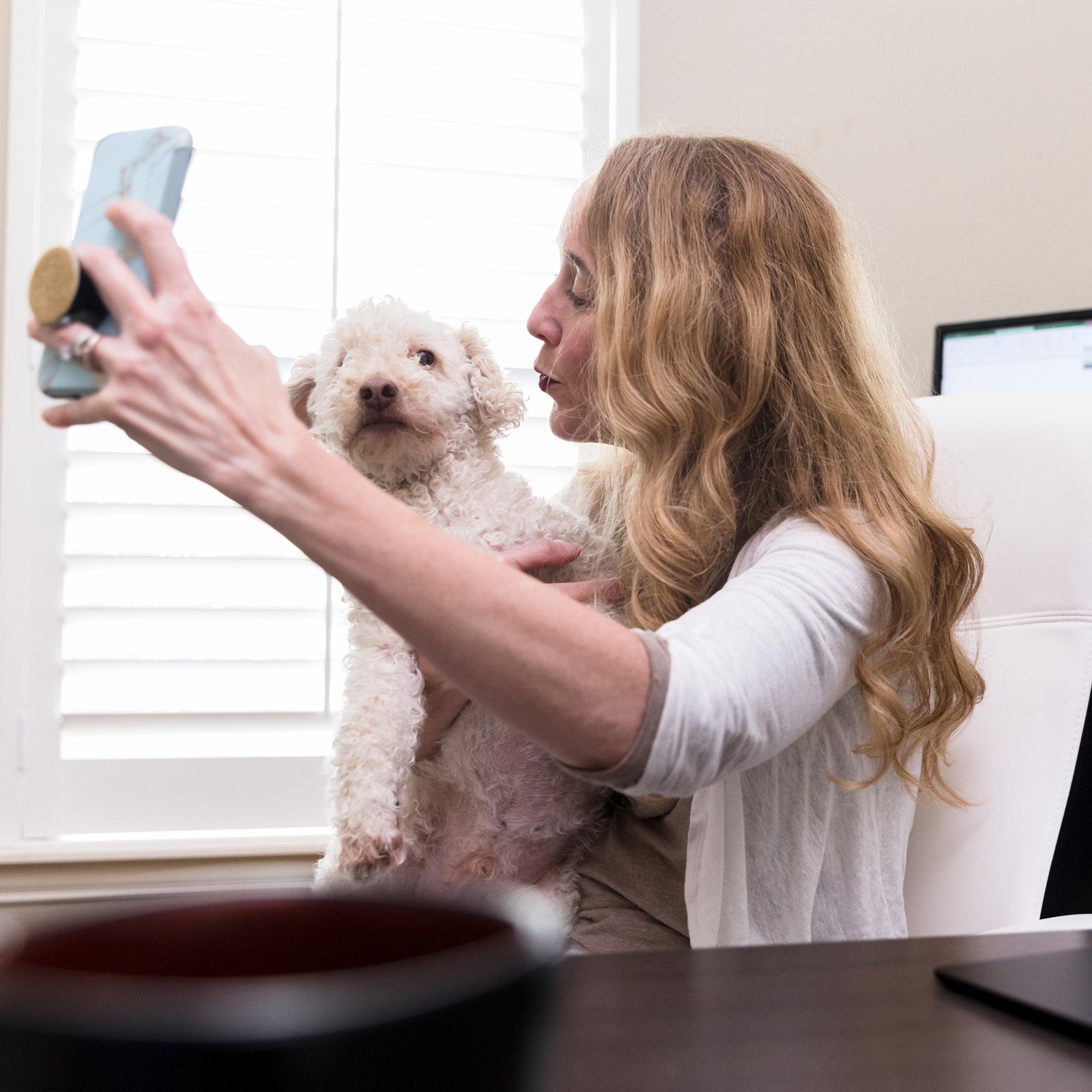 Woman taking selfie with dog