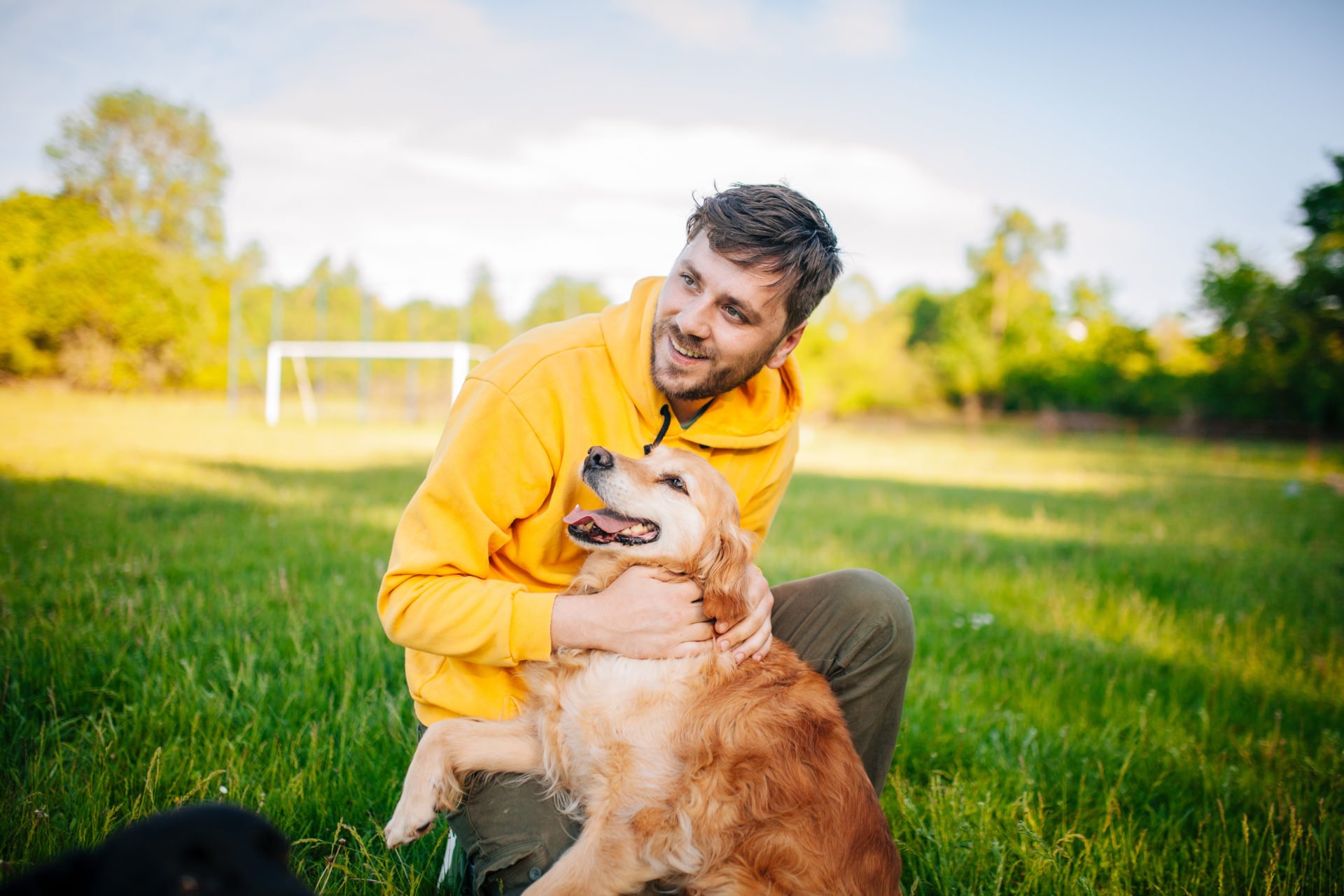 Young Man Having Fun With His Dogs