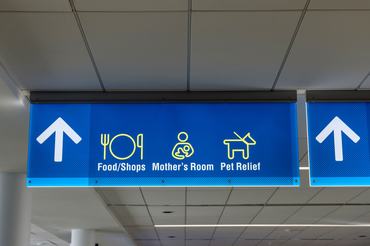 International Airport sign Food Shops Mothers Room Pet Relief in interior air terminal